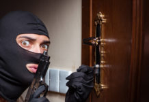 A settembre riprendono discussione e audizioni sulla riforma della legittima difesa rapinatore con passamontagna e pistola davanti a una porta chiusa: riprendono le audizioni sulla riforma della legittima difesa