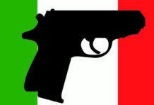 Fidasc sul recepimento della Direttiva armi: “Moderata soddisfazione” Pistola su bandiera italiana
