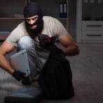 Burglar wearing balaclava mask at crime scene