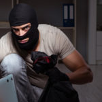 Burglar wearing balaclava mask at crime scene