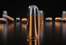 Divieto munizioni in piombo, le conseguenze socio-economiche Divieto munizioni in piombo: munizioni per pistola su fondo nero