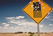 Porto d’armi vietato per trenta giorni in New Mexico Porto d’armi vietato per trenta giorni in New Mexico: cartello del deserto del new mexico segnato da colpi d'arma da fuoco